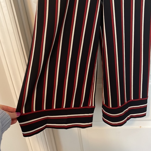 A fun and flirty navy jumpsuit with red/white accents! - Picture 2 of 3